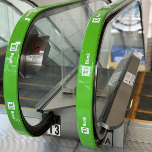 Green TD Bank escalator handrail advertising adrail