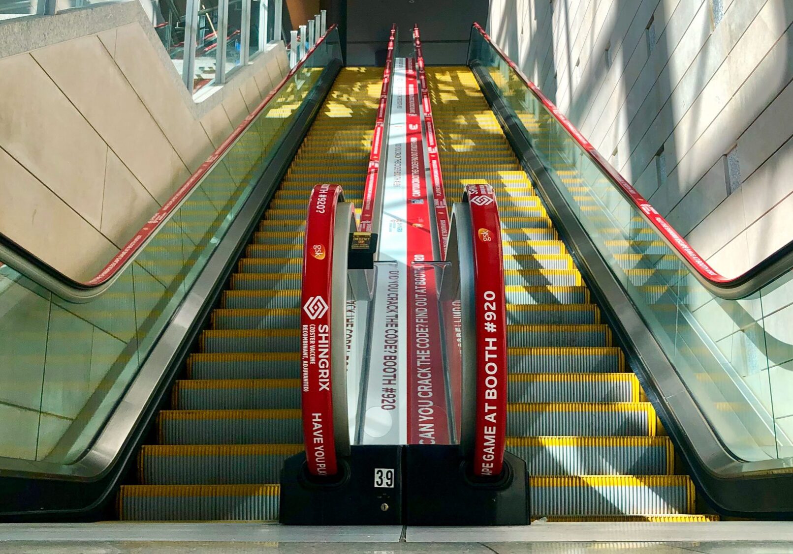mid-shot of shingrix adrail red escalator handrails